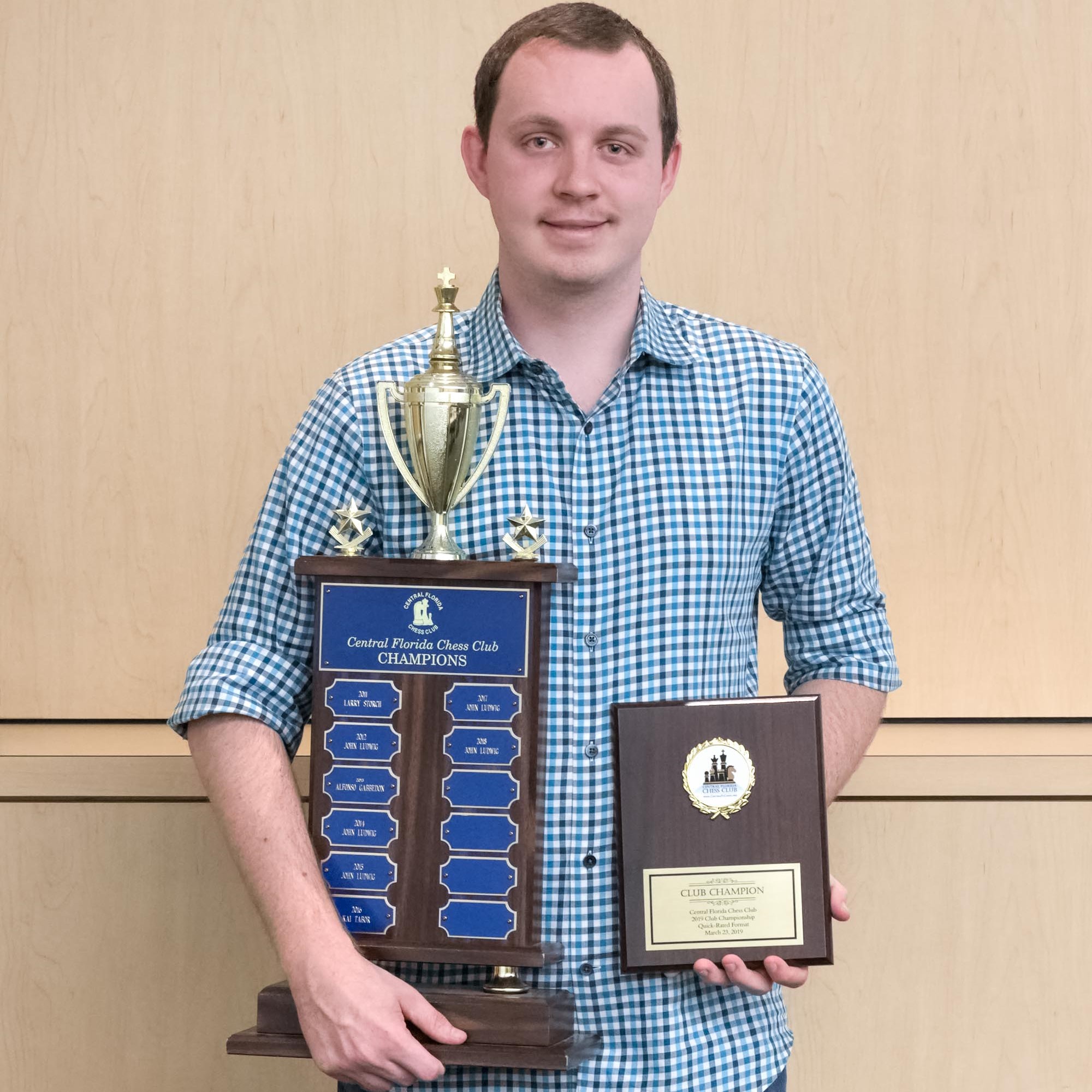 Dalton holding the Central Florida Chess Club Champion trophy