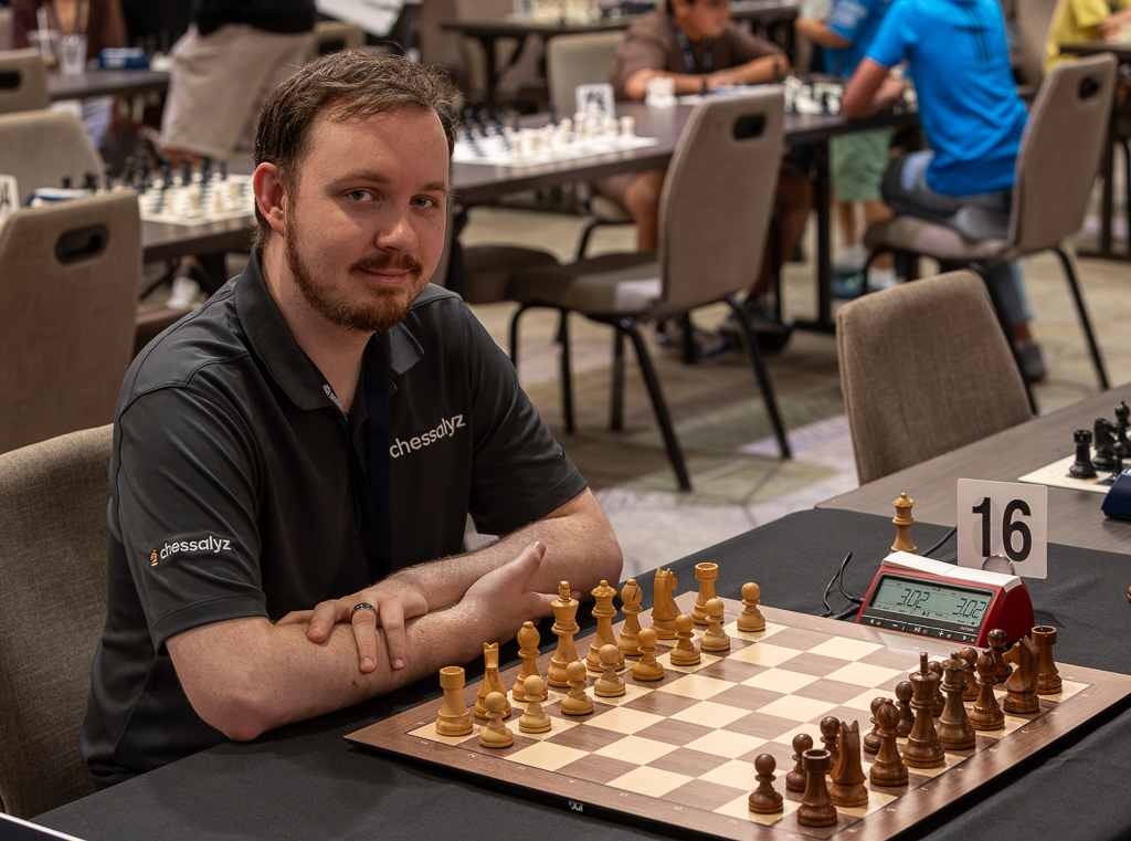 Dalton at the board in a Chessalyz polo, smiling