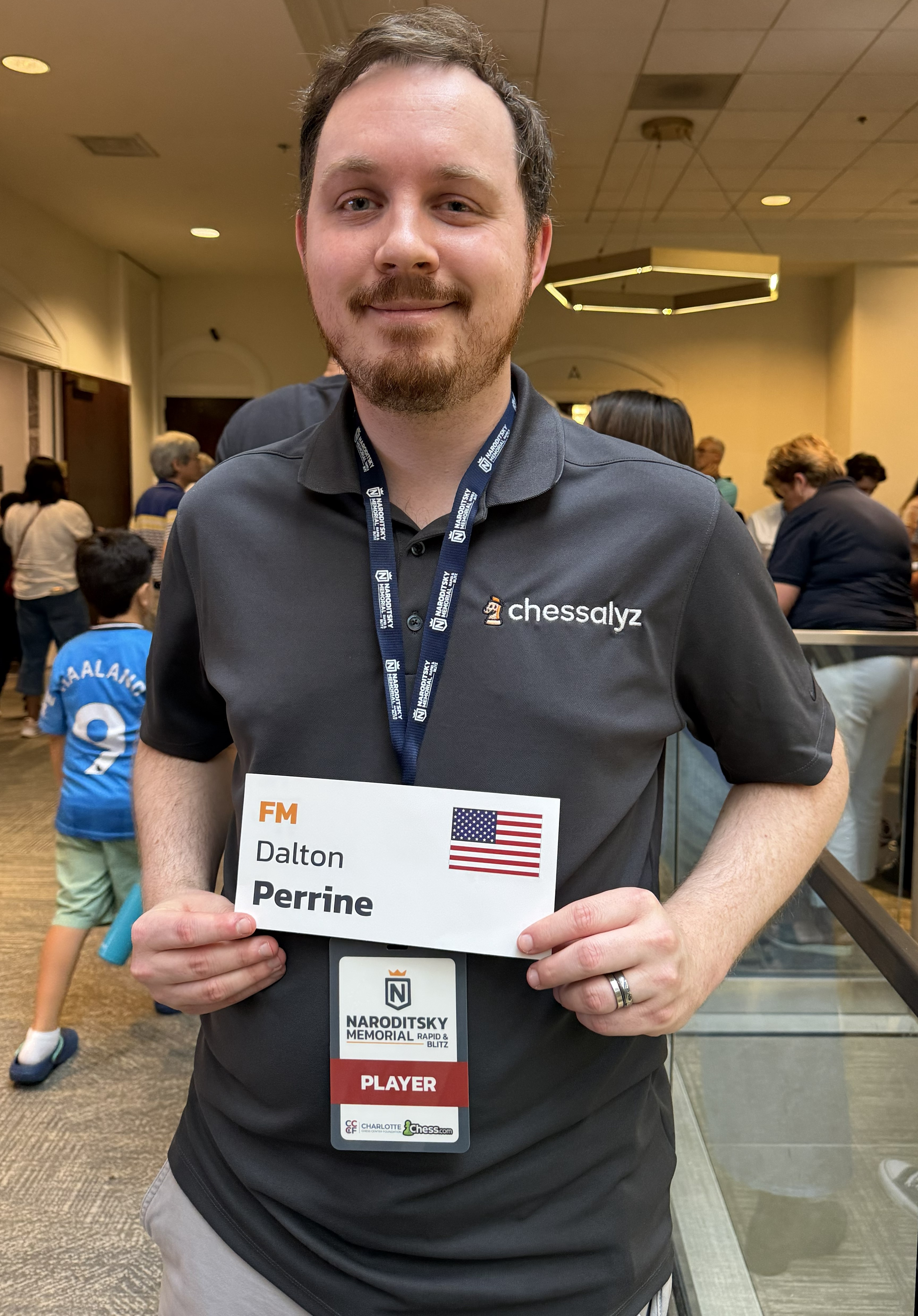 Dalton holding his FM name card at the Naroditsky Memorial Rapid & Blitz
